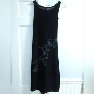 Small, black pull-over dress with beading.